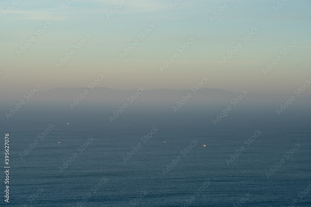View of Lisbon on the middle of the fog at sunrise seen from Cabo Espichel Cape, in Portugal