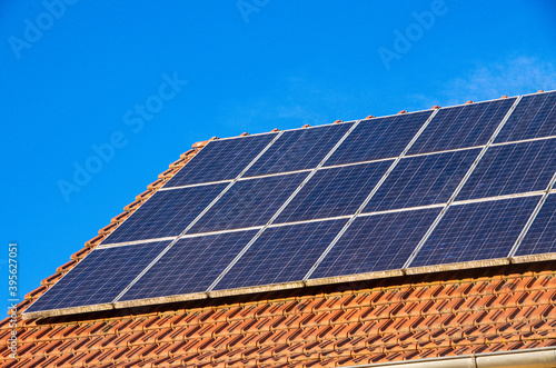 Old photovoltaic system on a red roof. High quality photo