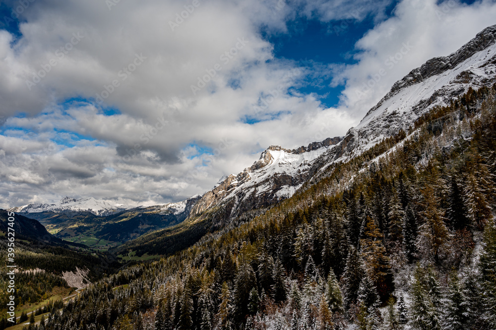 Obraz premium Winter landscape of snow covered mountains, green valley and trees. Glaciers 3000, Diablerets in Switzerland.