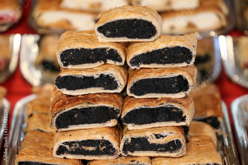 Various flavor strudel for sale in pastry shop photo