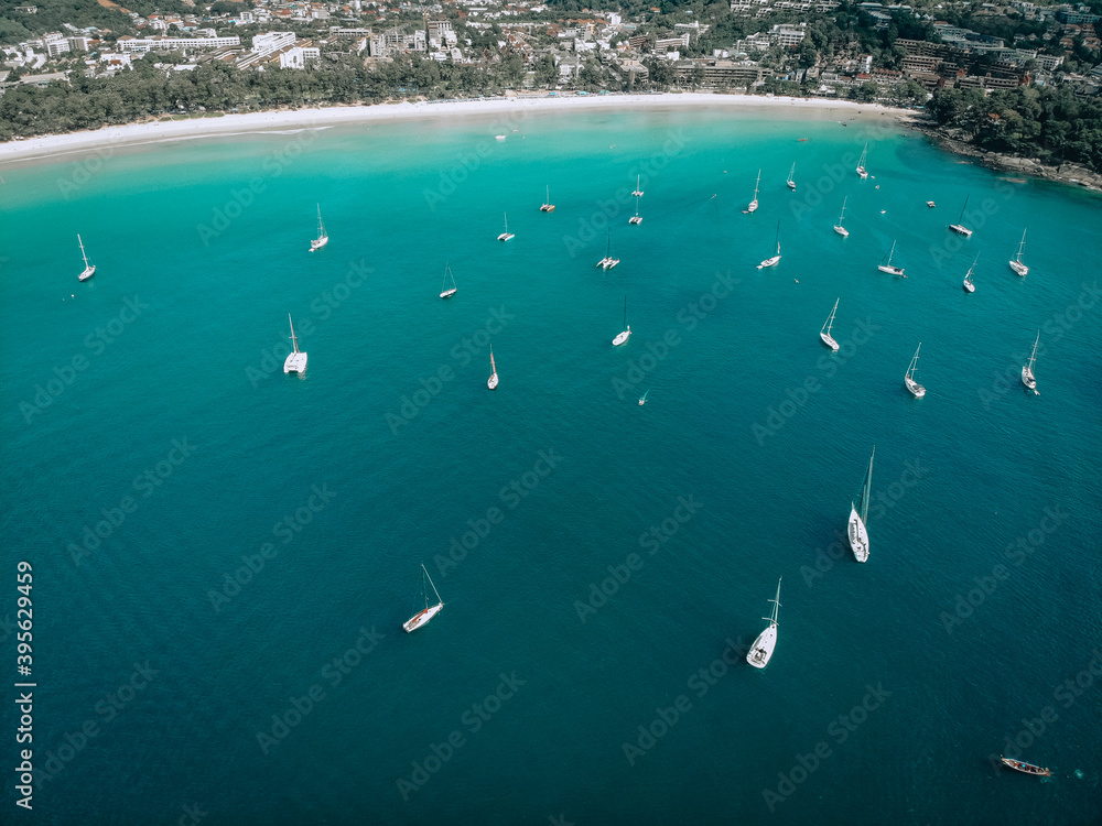 Aerial view of many anchoring yacht in open water. Ocean and sea travel and transportation