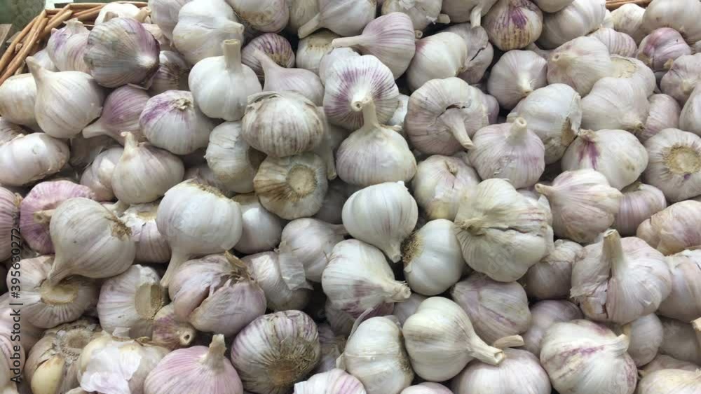 Garlic bulbs are on sale in supermarket, close up view as a background Garlic bulbs are on sale in supermarket, close up view as a background