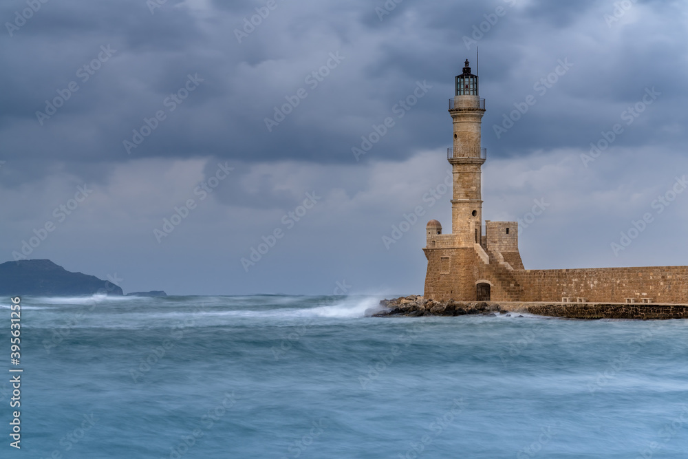 Chania lighthouse at the entrance to the stunning old venetian harbor. Chania, the second largest city of Crete, Greece