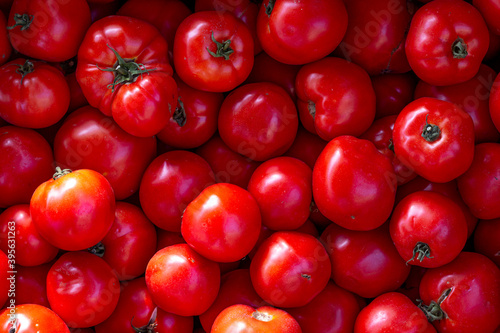Red tomatoes background. Juicy and fresh tomatoes pattern.
