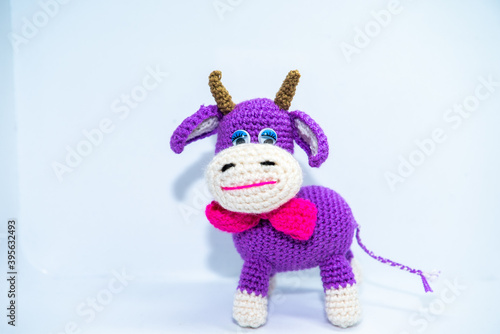 violet smiling cow toy isolated on violent background © Алина Конорева