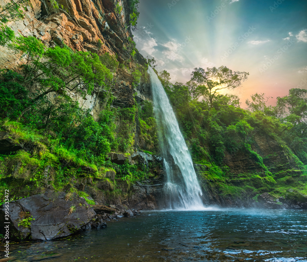 Lone creek waterfall and pond below during colorful sunset in Sabie Mpumalanga South Africa