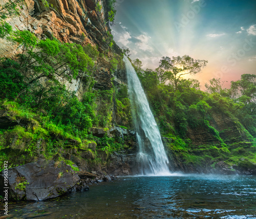 Lone creek waterfall and pond below during colorful sunset  in Sabie Mpumalanga South Africa