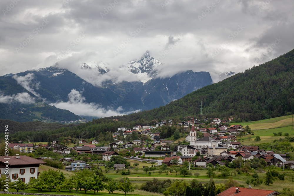 A village in the Alps among the mountain peaks.