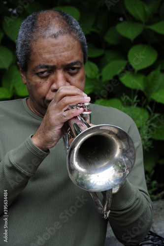 African american male with his flugelhorn outside.