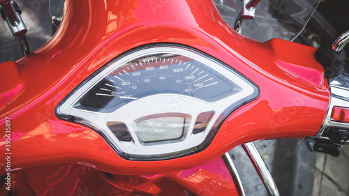 Speedometer on the handlebar of a glossy red motorcycle. Closeup photo © jockermax3d