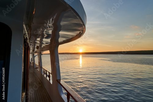 Fototapeta Naklejka Na Ścianę i Meble -  beautiful and spectacular sunset over a motor yacht with reflections on the white paint and details of the vessel, lying in the graet darwin bay of genovesa island, galapagos islands, Ecuador
