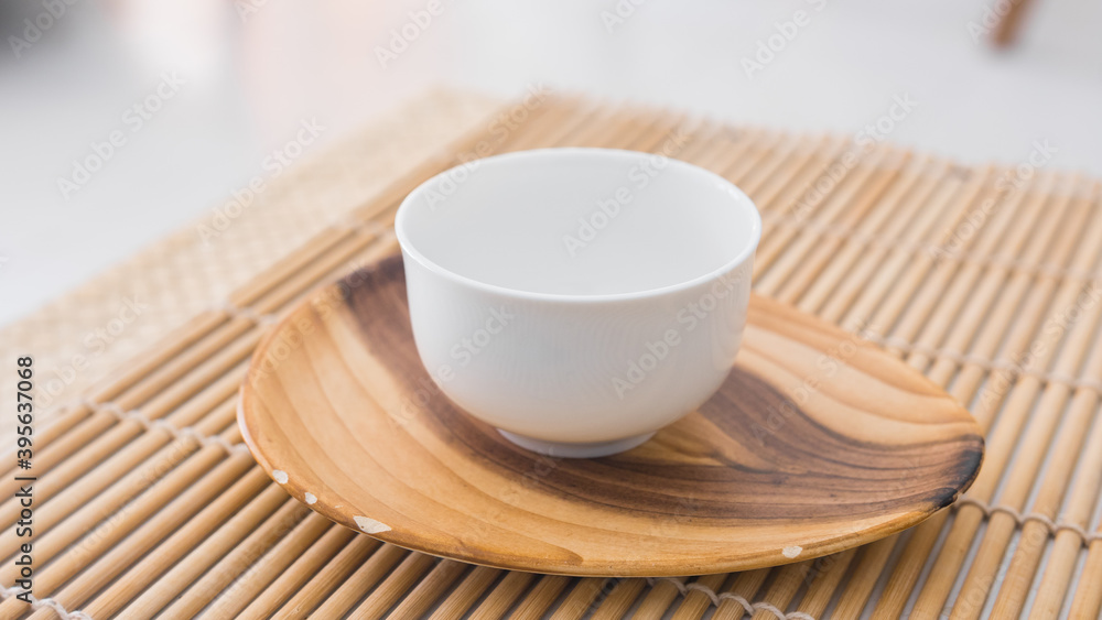 Beautiful white porcelain tea cup on a saucer close up Beautiful white porcelain tea cup on a saucer close up