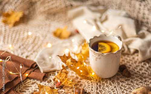 Autumn flatlay, Cup of warm tea fall style, fall scene with leaves, lights and acorns, cozy autumn aesthetic concept