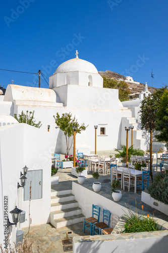 Tableau sur toile Small square with church building on street in beautiful Chora town on Folegandros Island, Cyclades, Greece