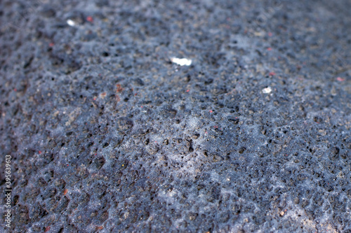 Background of black porous natural stone.