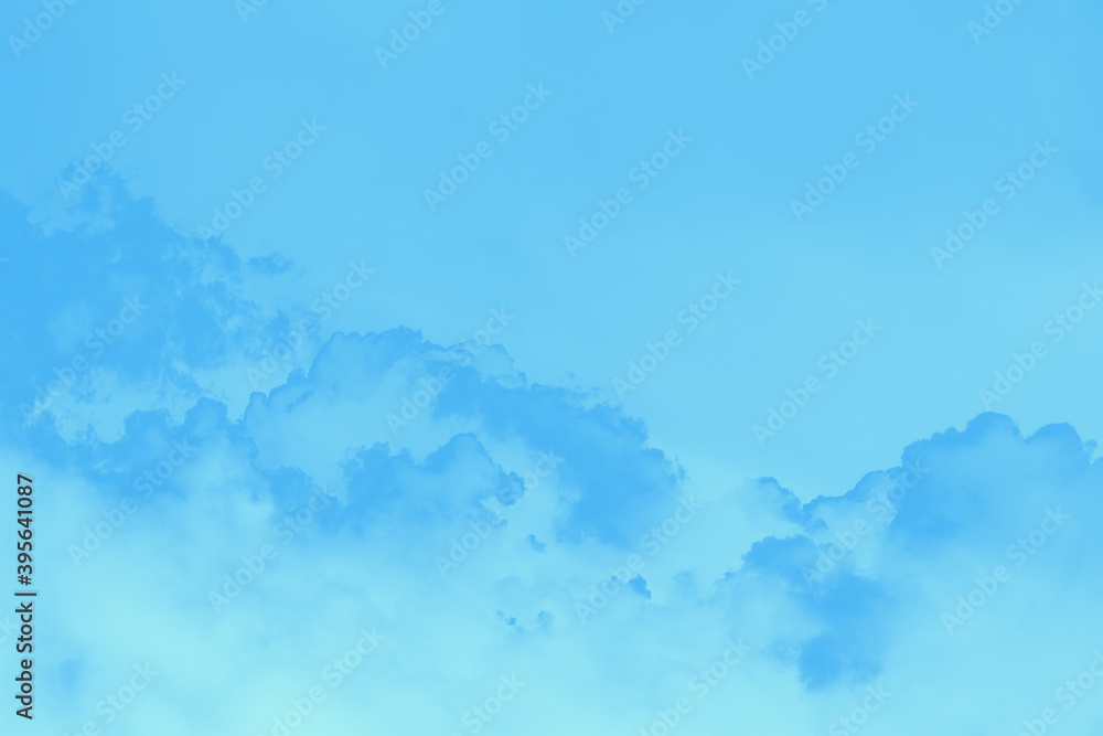 Scenic sky background. Blue sky with fluffy blue clouds, toned