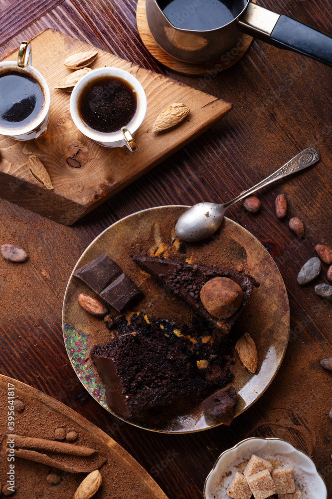  delicious chocolate truffles cakes with couple cups of coffee served at dark brown wooden table . life style concept. flat lay