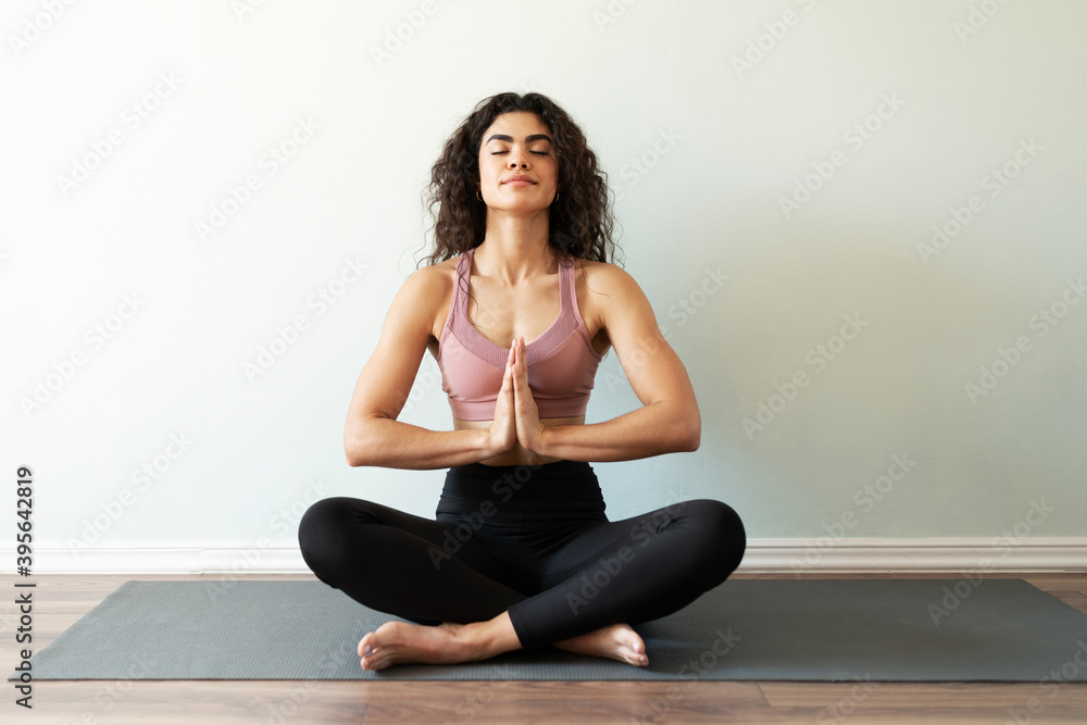 Latin woman meditating in a praying pose Latin woman meditating in a praying pose