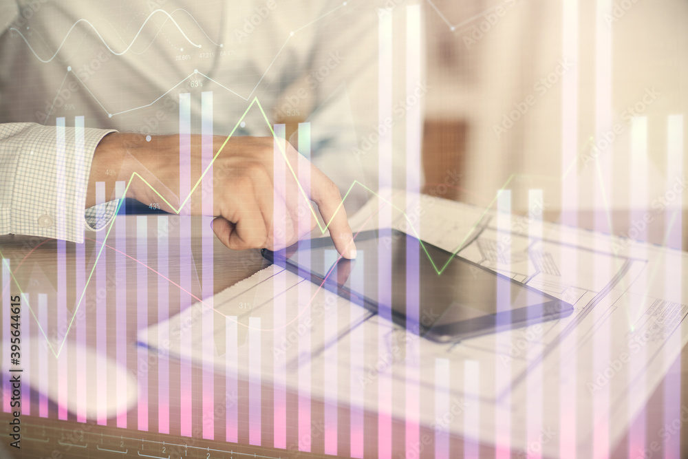 Double exposure of man's hands holding and using a digital device and forex graph drawing. Financial market concept. Double exposure of man's hands holding and using a digital device and forex graph drawing. Financial market concept.
