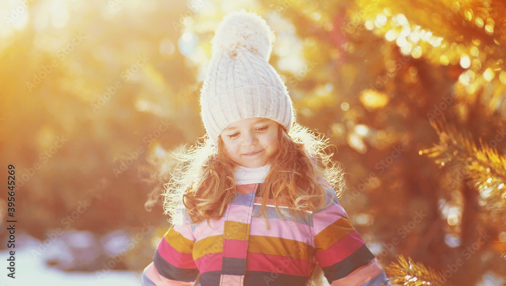 Happy smiling little girl child in winter over snowy background Happy smiling little girl child in winter over snowy background