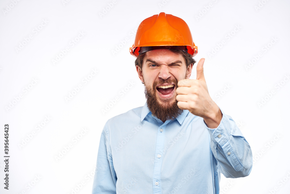 Emotional man in blue shirt orange helmet industry security Professional