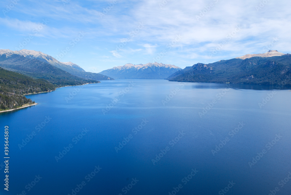 lake in argentinian patagonia. lake with mountains and blue sky in the background.
