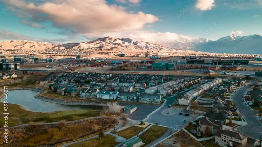 Aerial hyperlapse of a snowy mountain community with a train passing and a dynamic cloudscape Aerial hyperlapse of a snowy mountain community with a train passing and a dynamic cloudscape