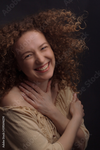 Studio portrait of a young woman with curly hair