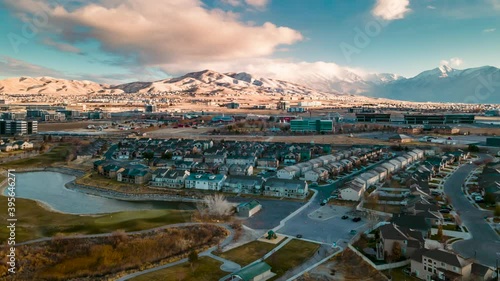 Wallpaper Mural Aerial hyperlapse of a snowy mountain community with a train passing and a dynamic cloudscape Torontodigital.ca