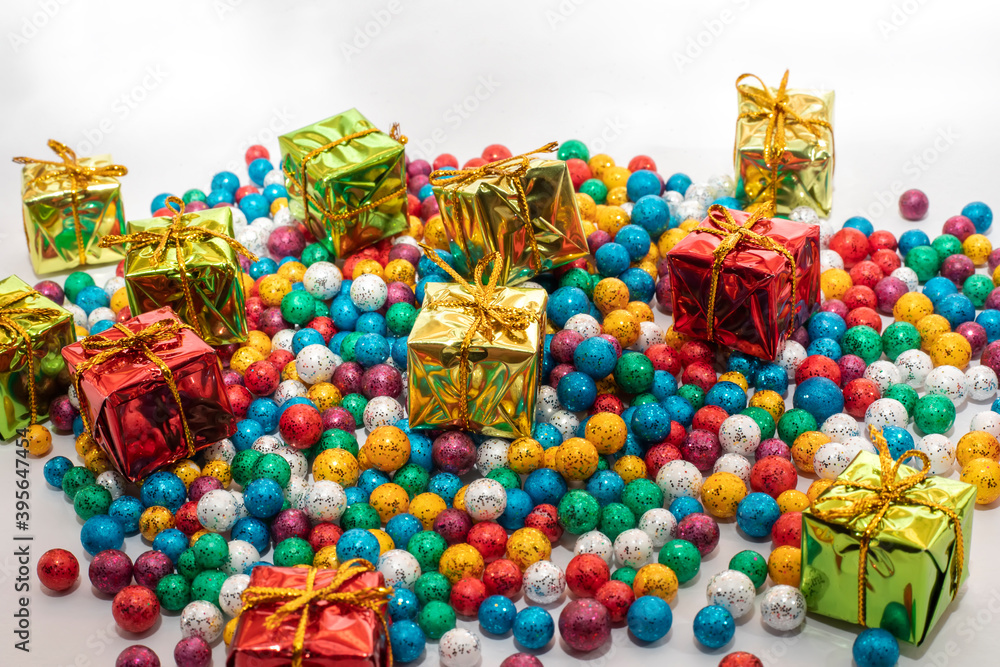 Gift boxes with colorful balls on white background.