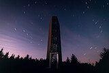 Lookout tower on hill Velka Destna in Czech republic at night with long exposure startrails