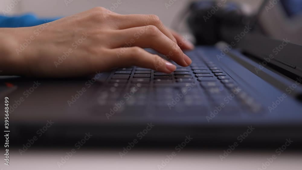Woman taps on the keyboard of her laptop - close-up - videoclip Woman taps on the keyboard of her laptop - close-up - videoclip
