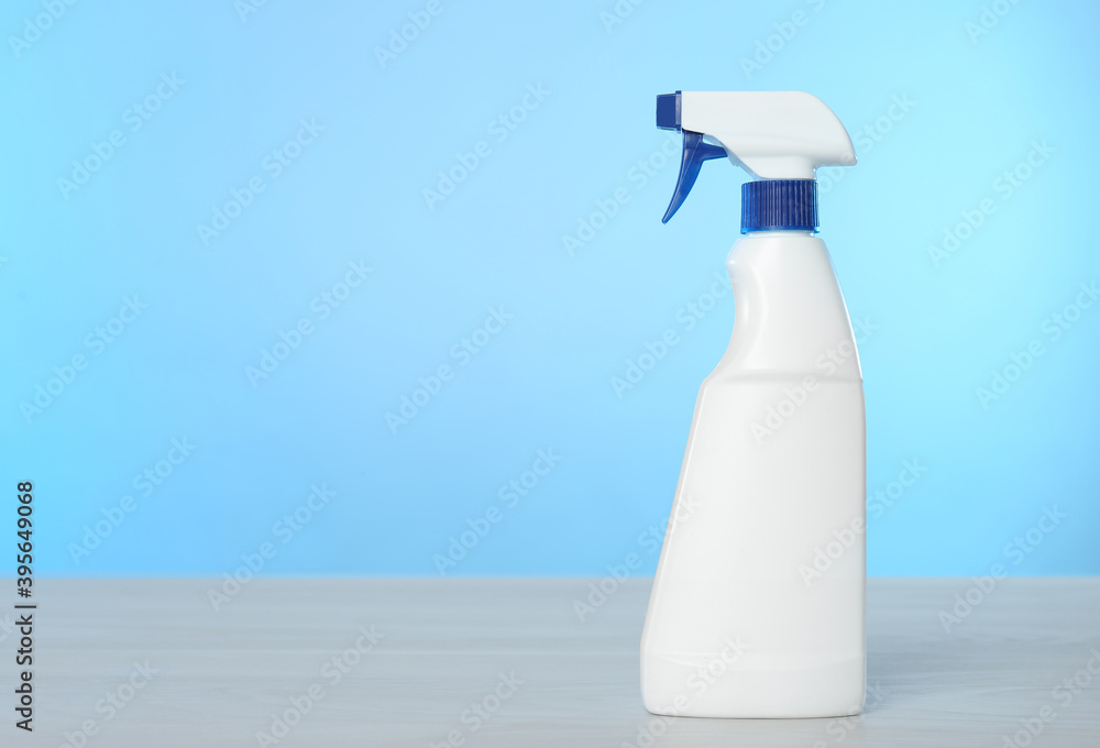 Bottle of cleaning product on light table. Space for text Bottle of cleaning product on light table. Space for text