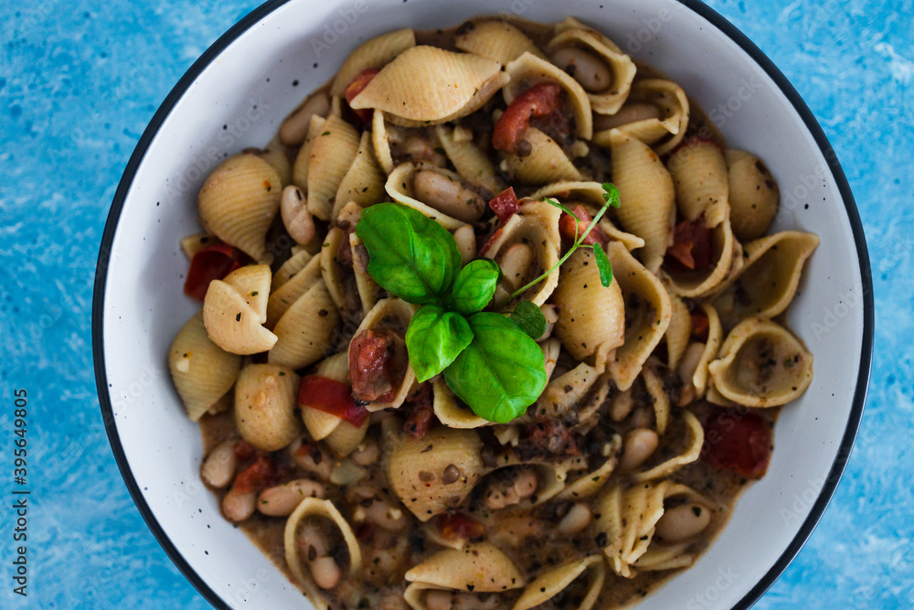 plant-based food, vegan mushroom sauce pasta with butter beans and chopped tomatoes plant-based food, vegan mushroom sauce pasta with butter beans and chopped tomatoes