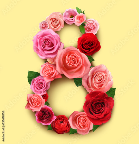 International women s day. Number 8 made of beautiful flowers on pale yellow background  top view