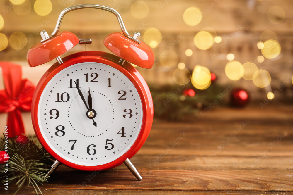 Alarm clock and Christmas gift on wooden table, space for text. Boxing day Alarm clock and Christmas gift on wooden table, space for text. Boxing day