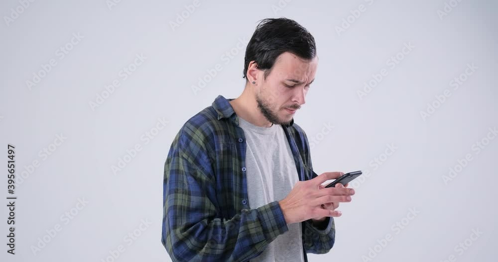 Upset men watching an unpleasant picture on a smartphone Upset men watching an unpleasant picture on a smartphone
