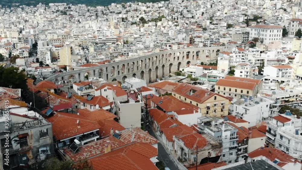 Kavala, Greece - August 13, 2020: Top view from Kavala city and Kavala aqueduct in the center of the city. Three tourists admiring the view . Kavala, Greece - August 13, 2020: Top view from Kavala city and Kavala aqueduct in the center of the city. Three tourists admiring the view .