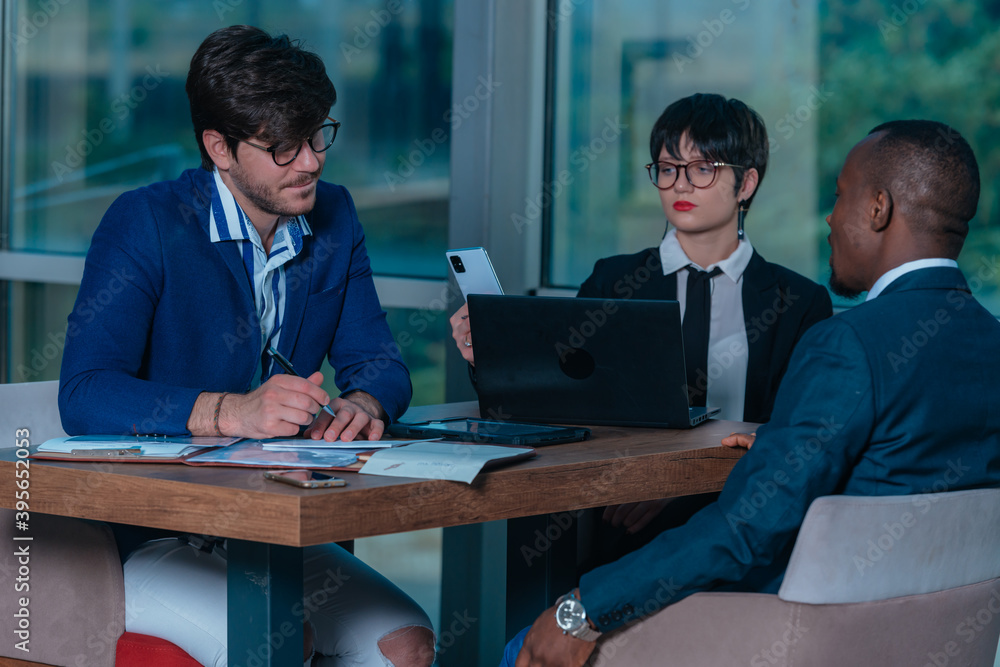 Female manager leads brainstorming meeting. Businesswoman in meeting with colleagues in conference room. Female manager leads brainstorming meeting. Businesswoman in meeting with colleagues in conference room.