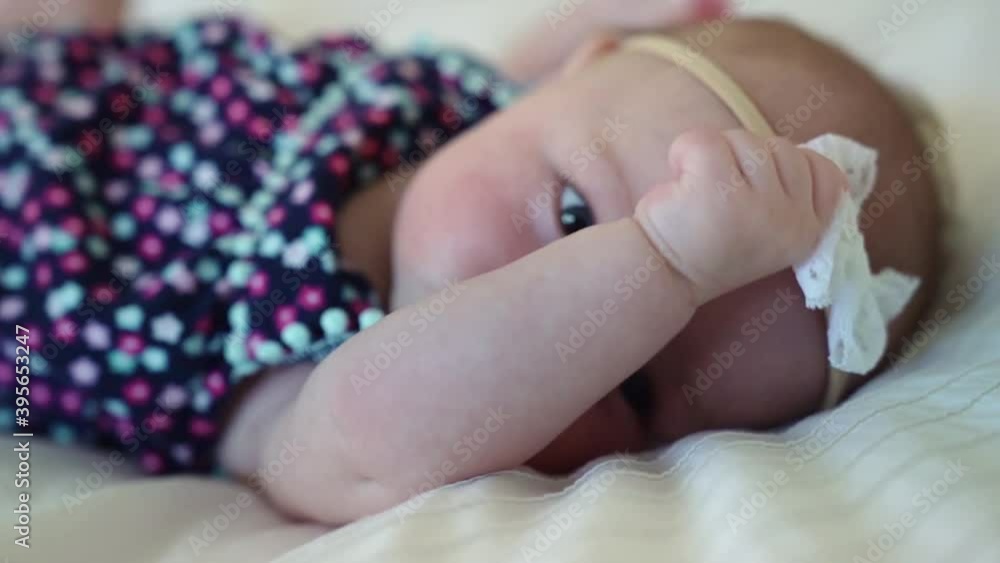 A funny baby girl lying on white bed A funny baby girl lying on white bed
