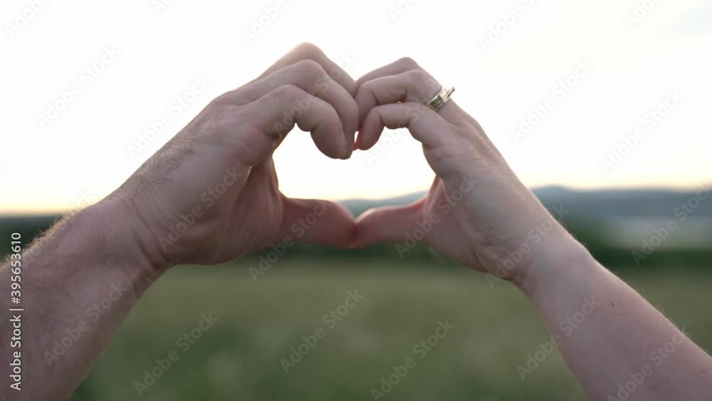 A nice couple love shape hand silhouette at sunset A nice couple love shape hand silhouette at sunset