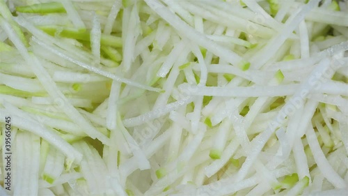 a thinly sliced korean radish in a bowl