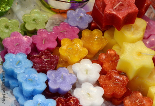 Colorful candles redy for sale at a christmas market. Decorative candles of different shapes in the store. photo