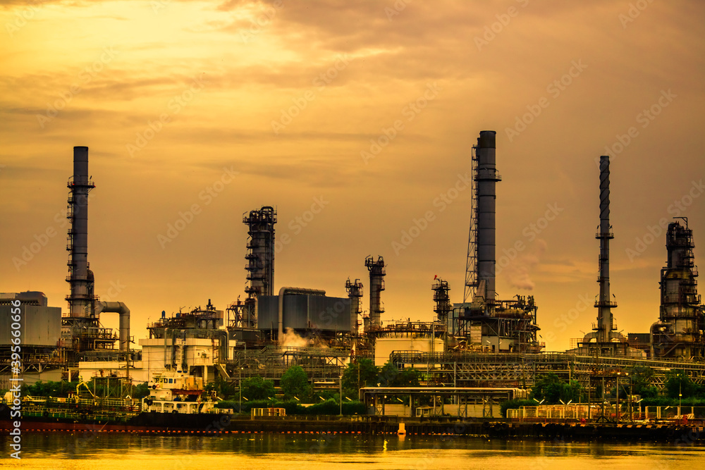 Fototapeta premium Blurred natural background of the morning sunshine along the river, breathtaking views (cargo ship, oil refinery), boat transportation