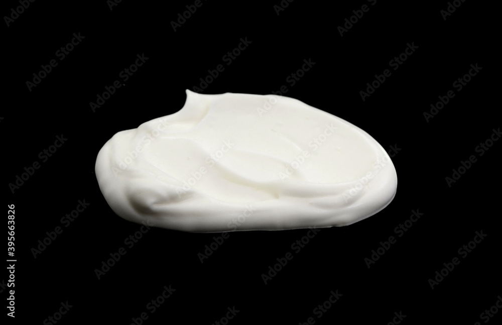 White whipped cream isolated on black background. Meringue on black. White whipped cream isolated on black background. Meringue on black.