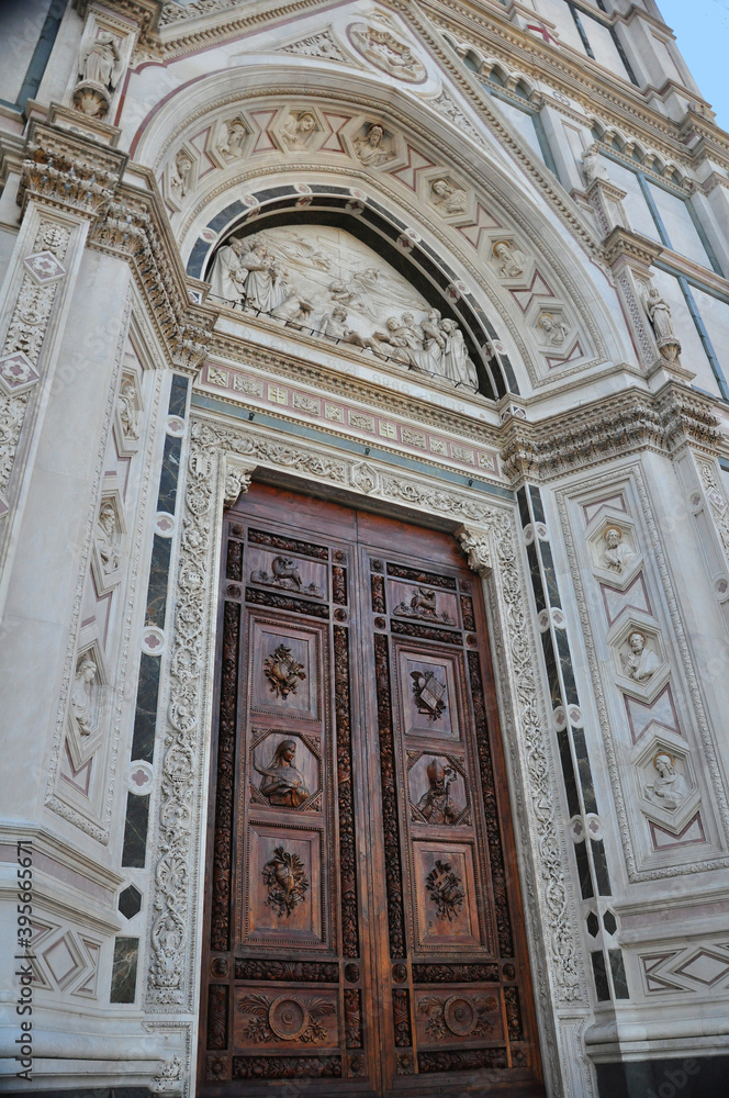 The Santa Croce Basilica in Florence. The basilica is also a mausoleum and the resting place of Michelangelo, Dante and Galileo. In this view the beautifully carved door is in focus.