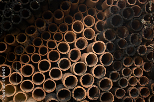 Long round pipes arranged in a pile