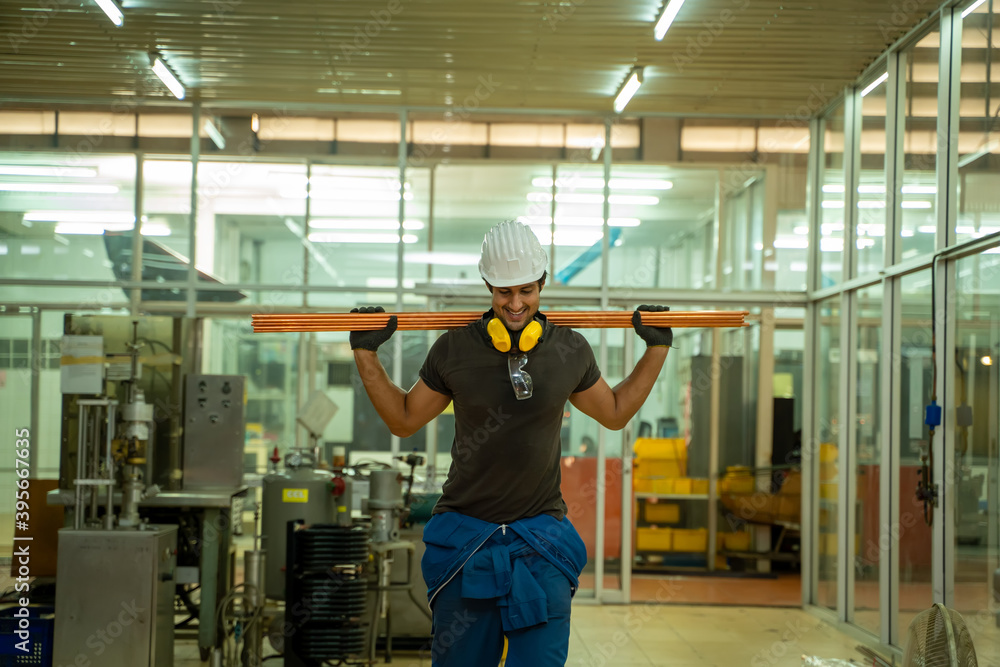 Factory worker in the hard hat and working about mechanical piece at old factory equipment. Factory worker in the hard hat and working about mechanical piece at old factory equipment.