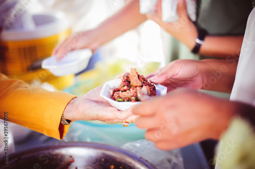 Volunteers give food to the poor: concept of charity food for the poor