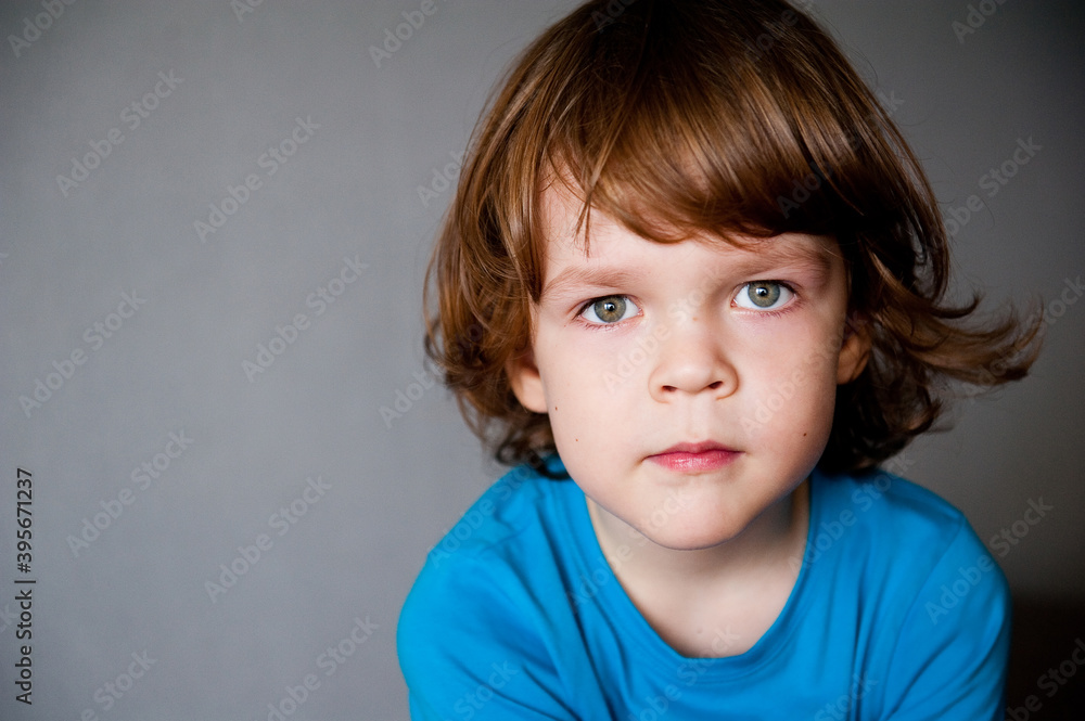 Portrait of a cute child on a gray background with space for advertising text. Portrait of a cute child on a gray background with space for advertising text.
